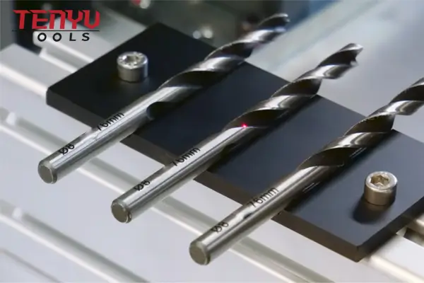 Laser etching machine applying a custom logo to a tool