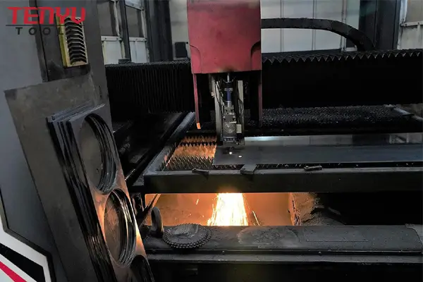 Close-up of laser cutting a saw blade blank from steel plate
