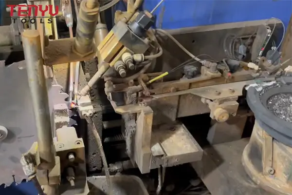 Microscopic cross-section showing carbide tip brazed to steel saw blade body