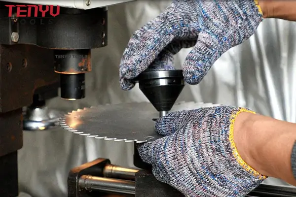 Quality control technician inspecting a finished circular saw blade