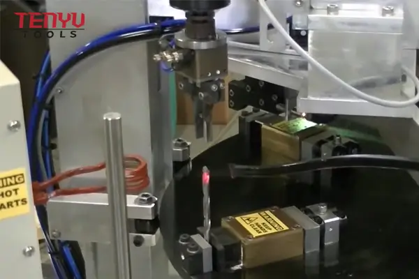 Close-up view of a carbide tip being brazed to a steel drill bit body