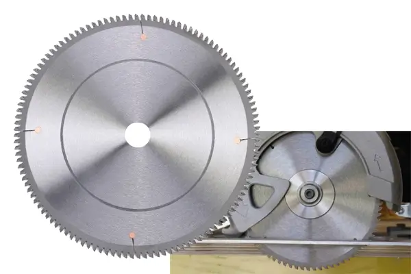 Assortment of industrial aluminum cutting blades on a steel table