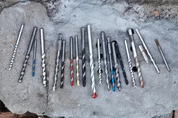 Close-up of masonry drill bits showing tungsten carbide tip and flute design